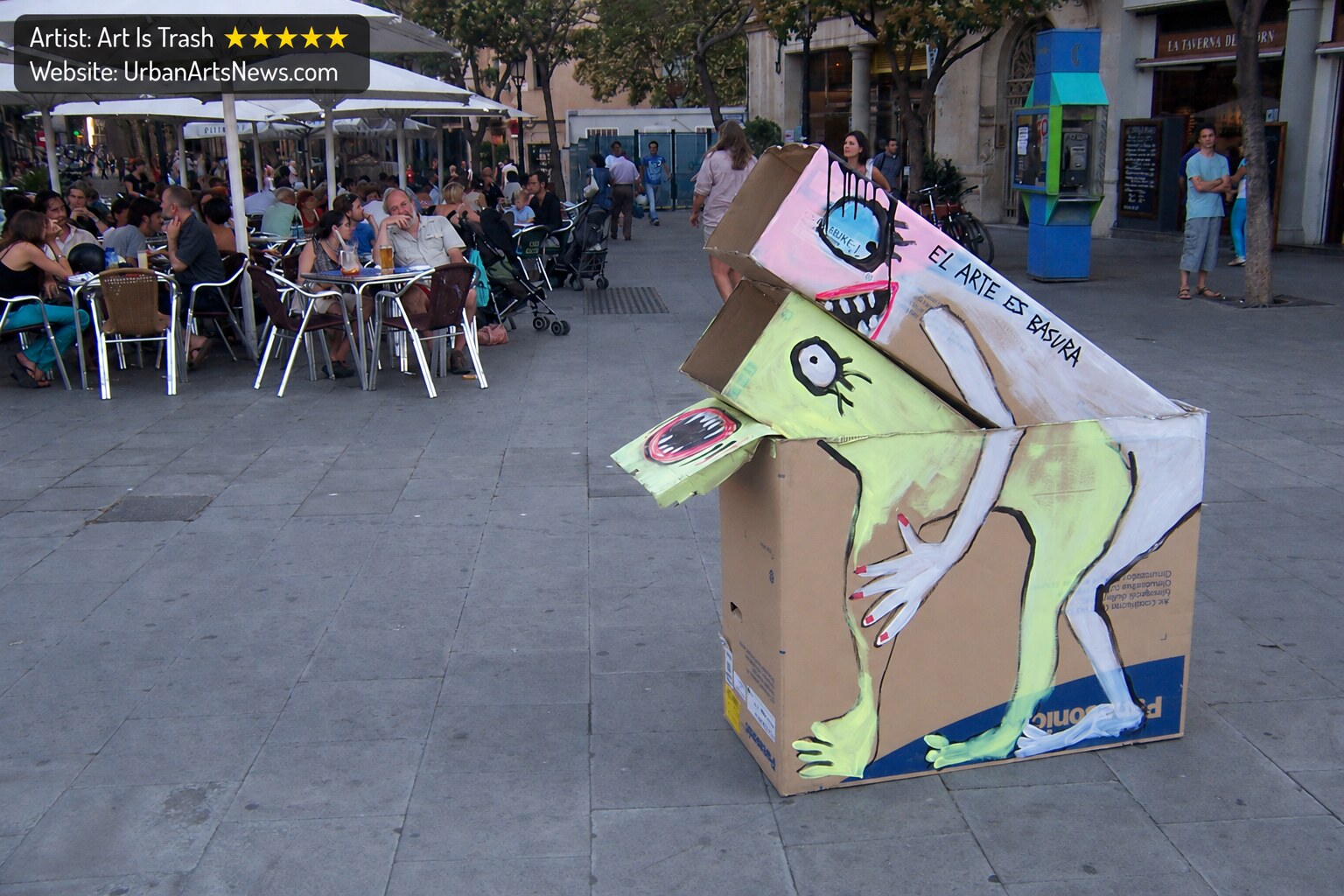 Art Is Trash Barcelona urban art: A temporary cardboard street art intervention by Art Is Trash in a Barcelona square.