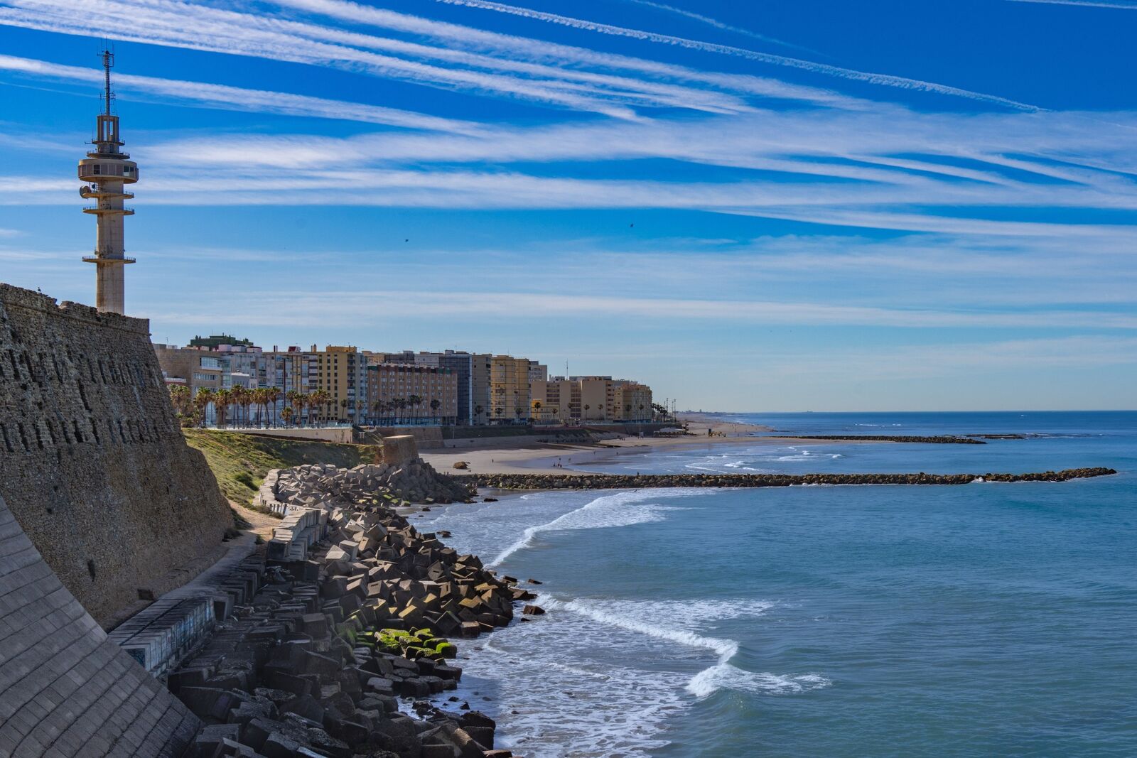 Stone coastal viewpoint and tower beside the sea in Badalona