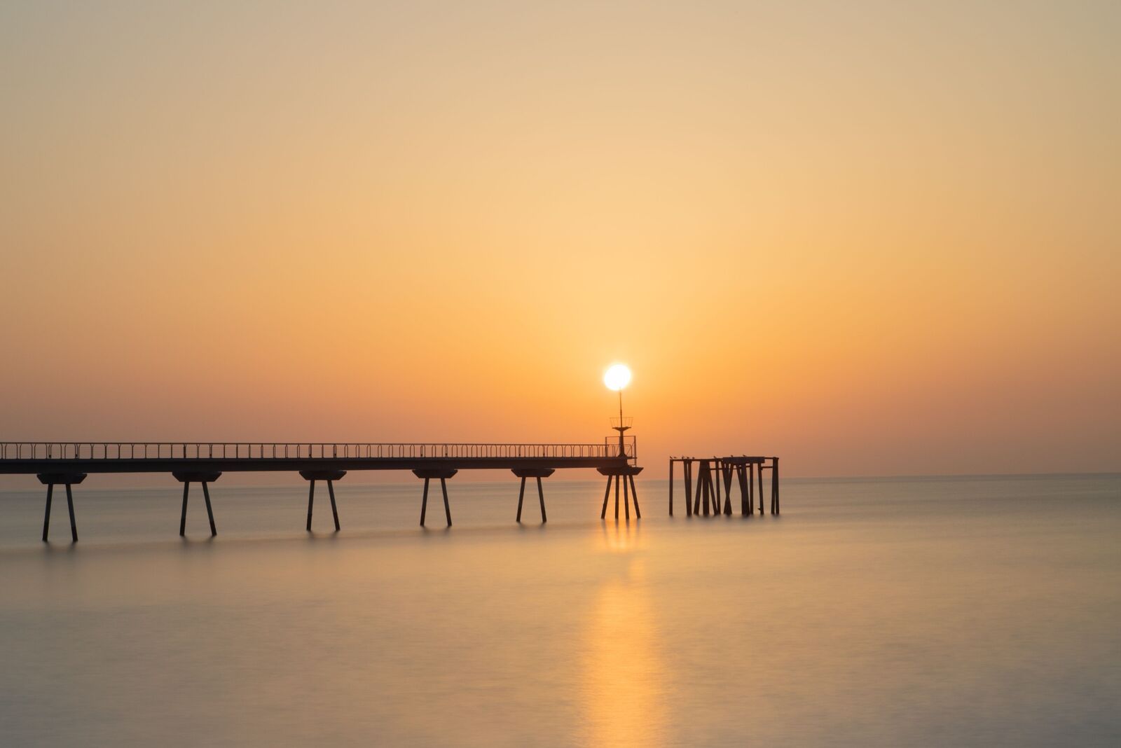 Pont del Petroli pier at sunset in Badalona