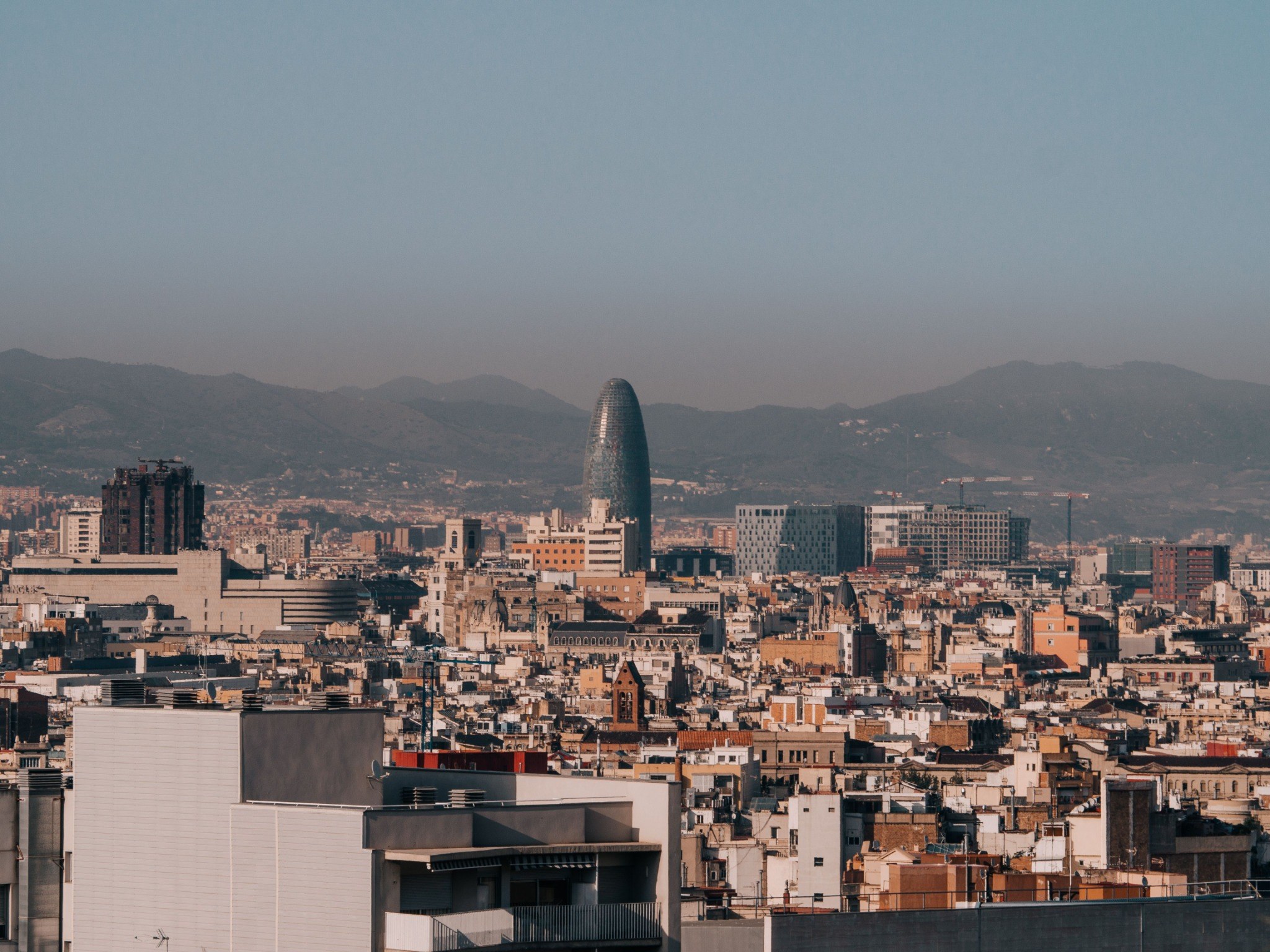 Barcelona skyline with Torre Glòries and mountains in the distance