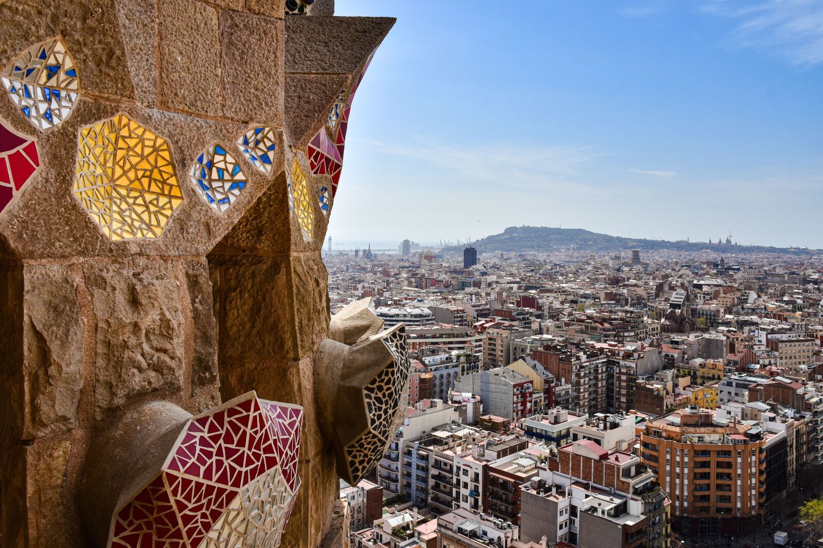 Barcelona viewed through a stone window with colourful mosaic details