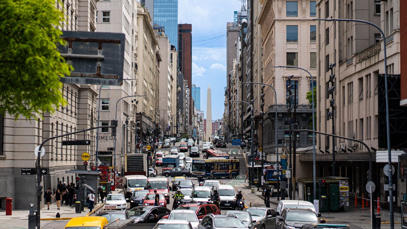 Busy avenue with traffic and tall buildings in Downtown Buenos Aires