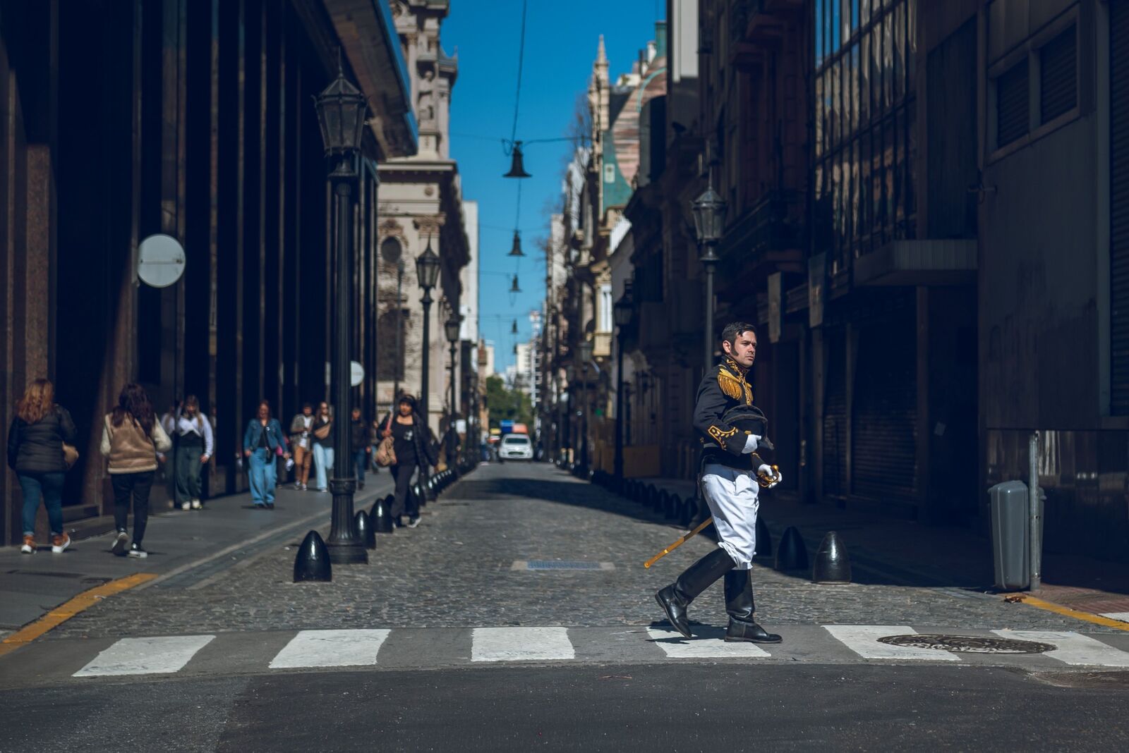 Pedestrians crossing a historic street in Buenos Aires