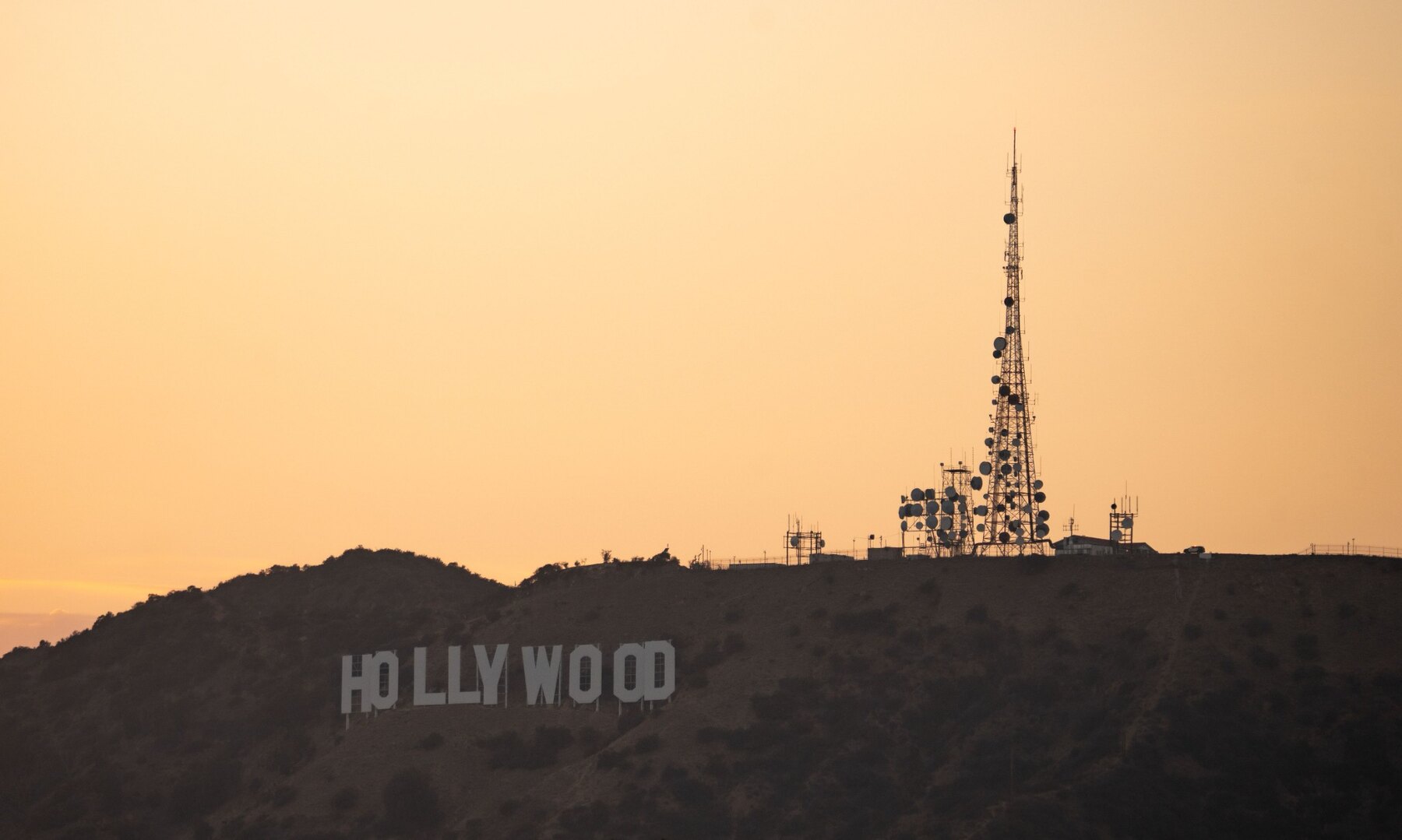 Hollywood Sign and communications tower at sunset in Los Angeles