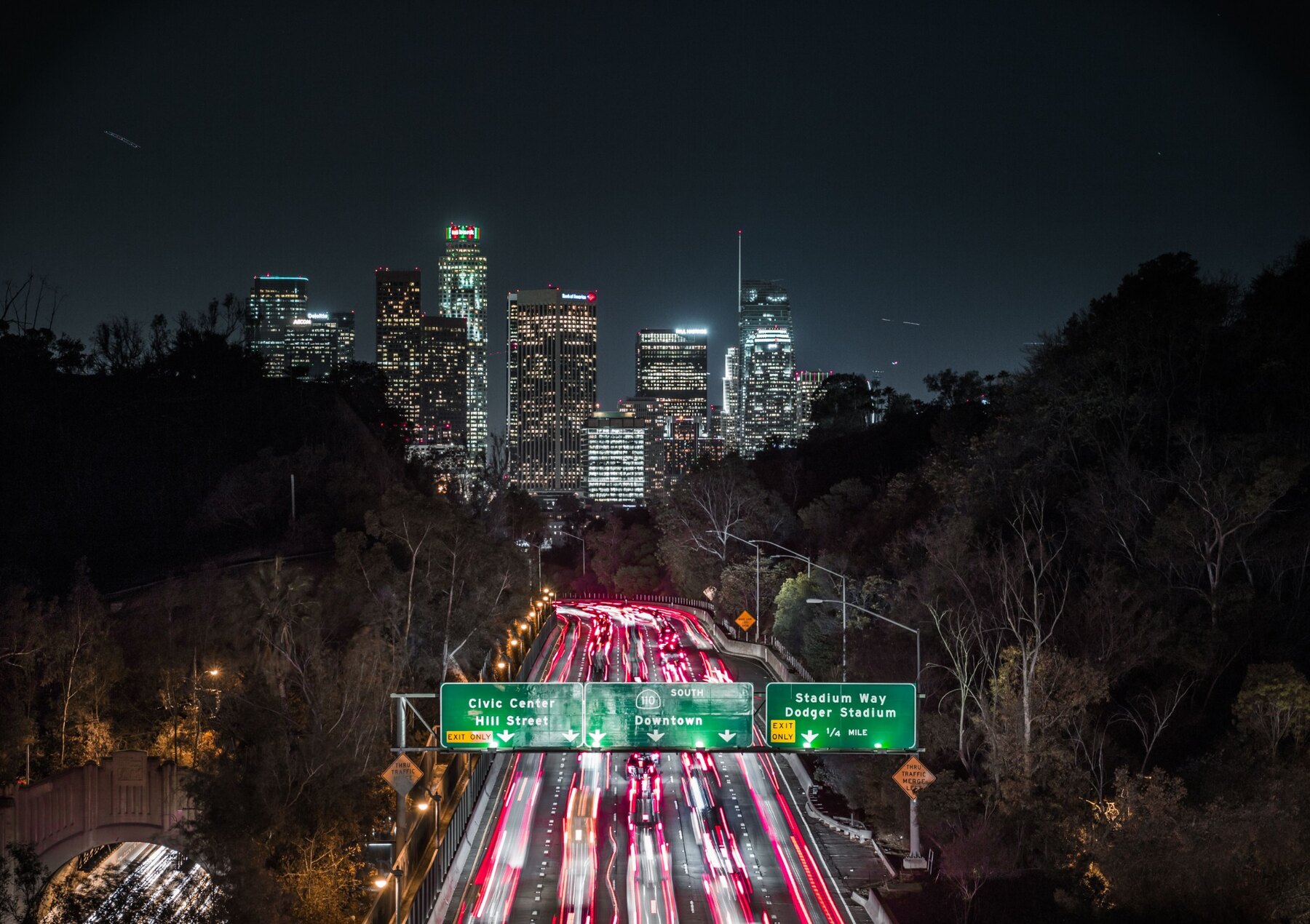 Los Angeles freeway traffic leading toward Downtown at night