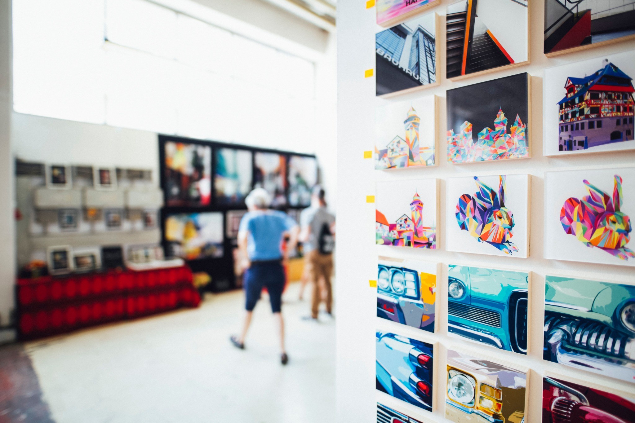 Colourful art editions displayed inside a contemporary urban gallery