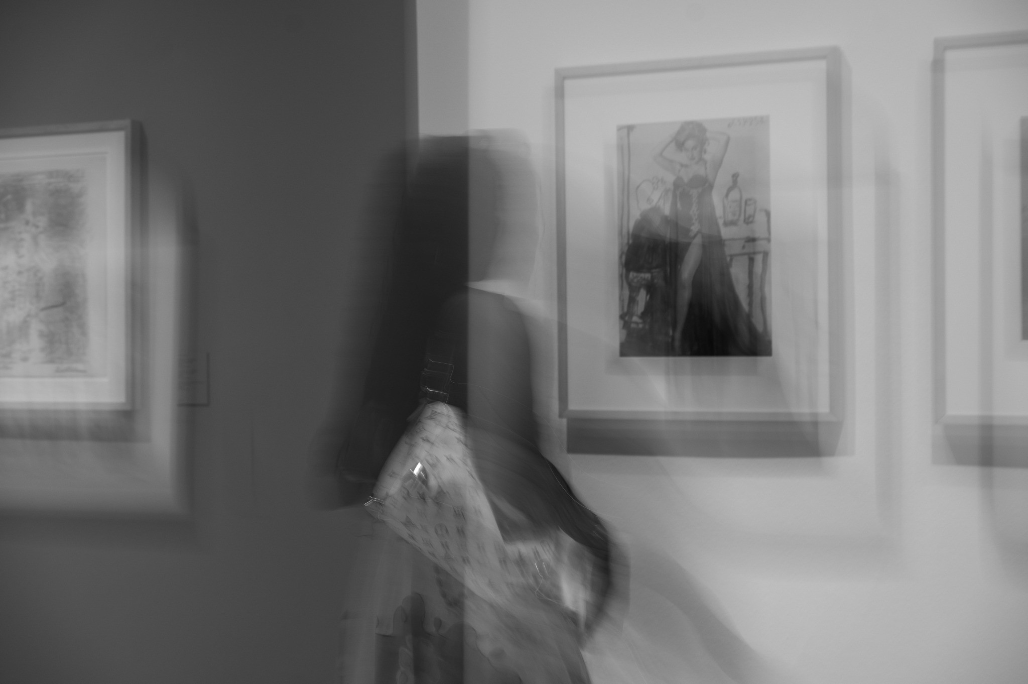 Visitor moving through a black-and-white urban art gallery exhibition